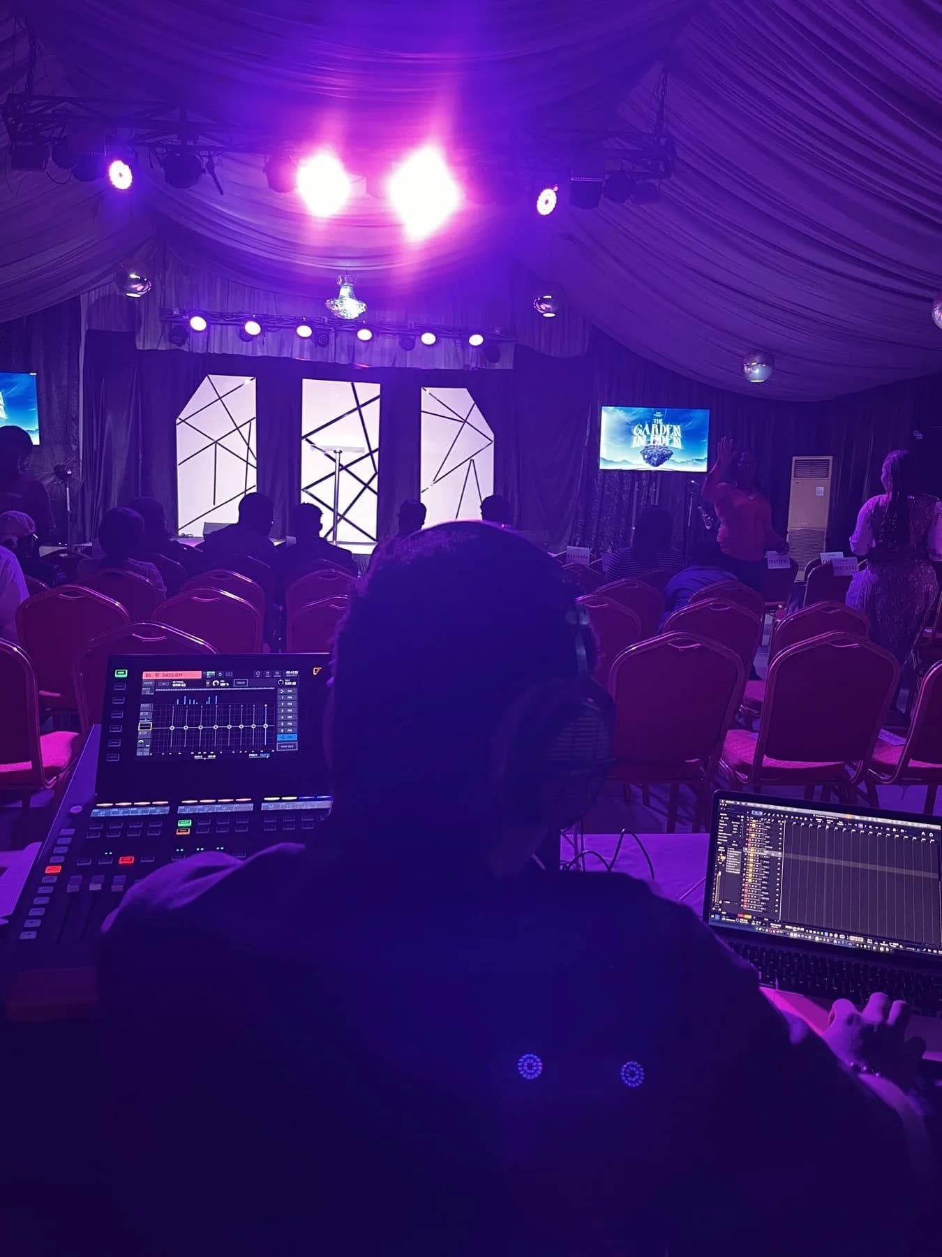 A live-sound operator learning from the front-of-house position at a real venue